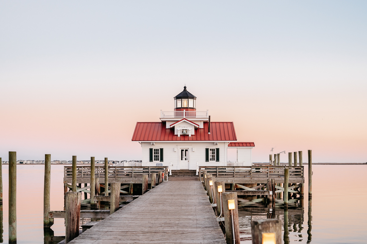 Sunset view over water and small lighthouse