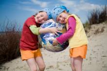 2 girls holding earth beach ball
